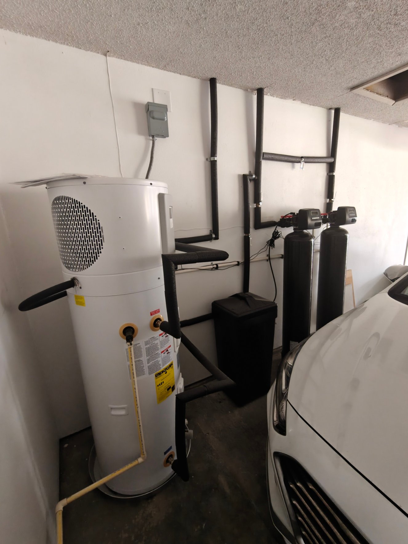 Whole-home water treatment system installed in a garage