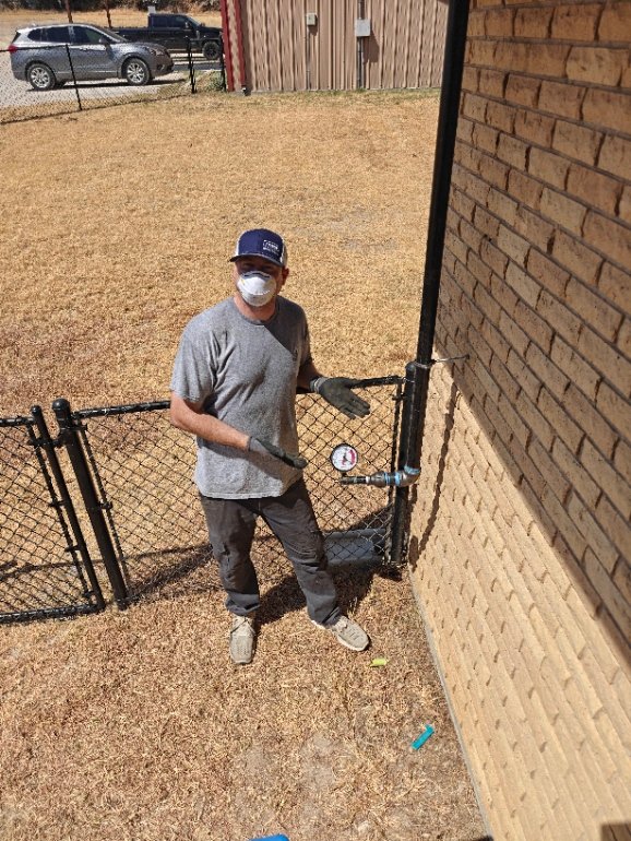 Circle T plumber pressure-testing a residential gas line with a gauge
