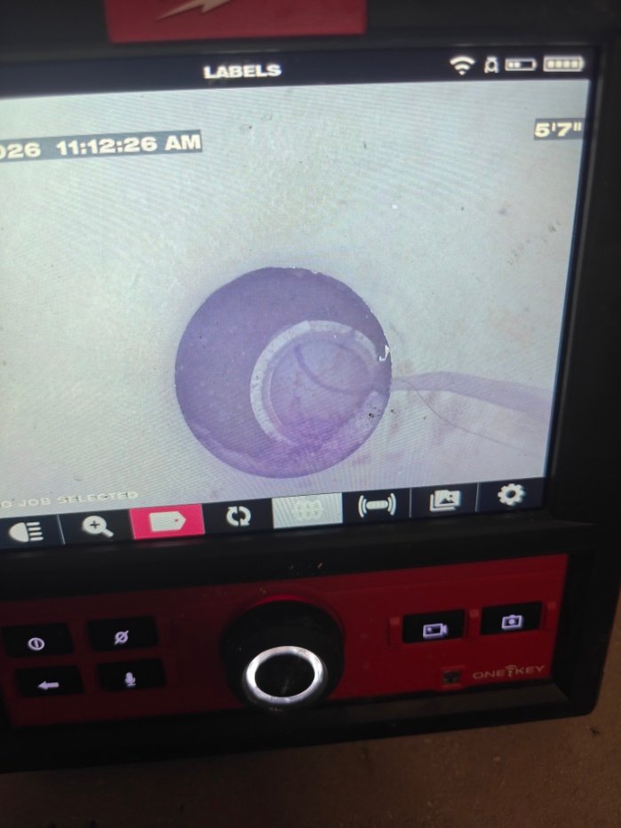 Sewer camera monitor showing the inside of a sewer line