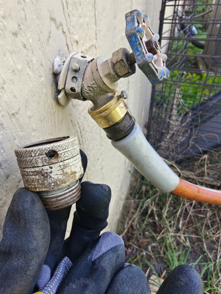 Worn outdoor hose bib being repaired